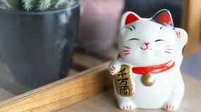 Figurka maneki-neko na parapecie