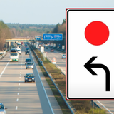 Znak drogowy z czerwoną kropką na białym tle