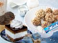 Na stole słodkości: lody w waflu, ciasto, kulki orzechowe i cukierki, mleko