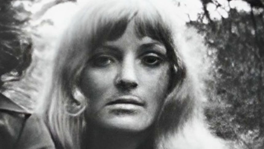 Na zdjęciu portret kobiety z długimi włosami, w odcieniach czerni i bieli.