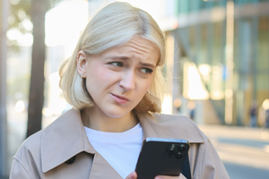 Kobieta czytająca wiadomość na telefonie