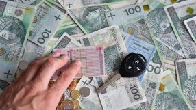 dowod rejestracyjny i kluczyki leżące na pieniądzach