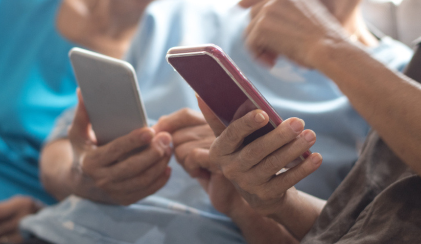 kobiety trzymają w dłoniach telefony komórkowe 