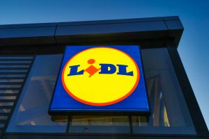 Logo sklepu Lidl na jasnym tle, umieszczone na ścianie budynku.