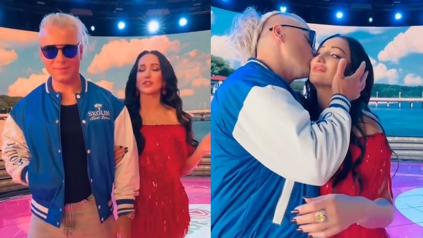 Na zdjęciu Skolim i Justyna Steczkowska w kolorowych strojach, pozują na tle jasnego nieba i wody.