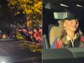 Anna Lewandowska za kółkiem, uśmiecha się, wokół tłum ludzi robiących zdjęcia. Nocna sceneria.