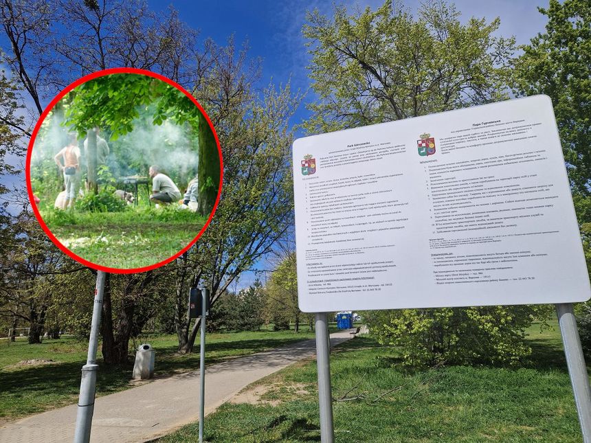 Na zdjęciu widać mężczyzn grillujących w parku, z zielonymi drzewami w tle.