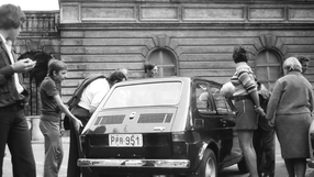 Grupa ludzi wokół samochodu Fiat 126p, czyli 