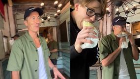 Na zdjęciu Robert Lewandowski i Bagi w lokalu. Jeden je jedzenie, drugi rozmawia. W tle widać rustykalny wystrój.