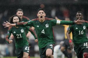Na zdjęciu piłkarze reprezentacji Meksyku cieszą się po zdobyciu bramki w deszczowej atmosferze.