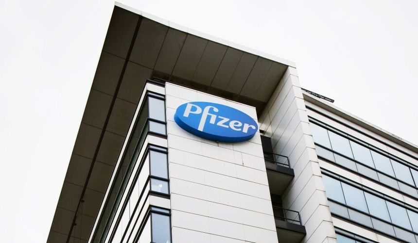 Budynek firmy farmaceutycznej Pfizer z dużym, niebieskim logo na ścianie.