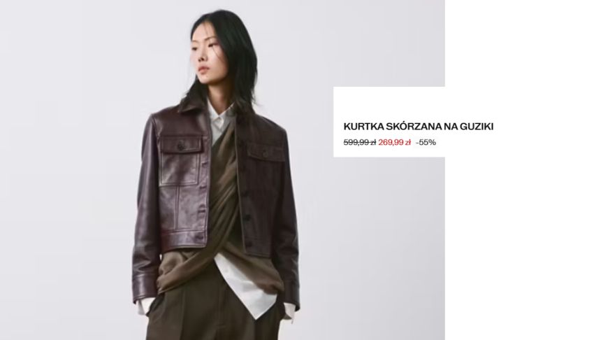 Modelka w skórzanej kurtce na guzikach, ubrana w białą koszulę i zielony sweter.