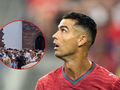 Na zdjęciu widoczny Cristiano Ronaldo w czerwonym stroju, spoglądający w górę, otoczony tłumem.