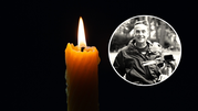 Świeca w ciemności z płonącym ogniem. W tle okrągłe zdjęcie uśmiechniętego mężczyzny.
