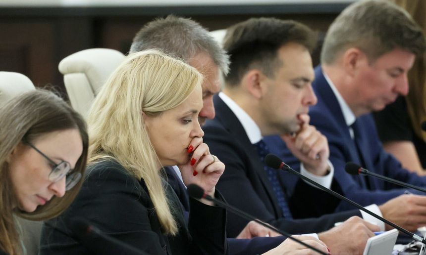 Na zdjęciu siedzi pięć osób, zajętych dyskusją w trakcie spotkania.