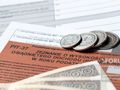 Opis ALT: Dokumenty podatkowe (PIT-37) z monetami oraz banknotami w tle.