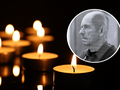 Zapalone świeczki na czarnym tle, w tle zdjęcie w okręgu mężczyzny z zamyśloną miną.