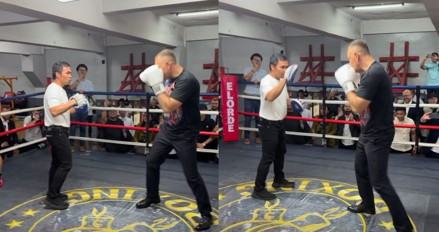 Karol Nawrocki i Manny Pacquiao w ringu bokserskim, publiczność obserwująca z widowni. 