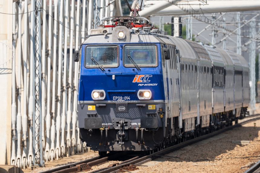 Lokomotywa elektryczna EP09-014 PKP Intercity na torach, przejeżdżająca przez stację.